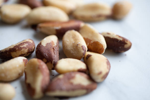 istock Brazil nuts on white marble background 1194092355