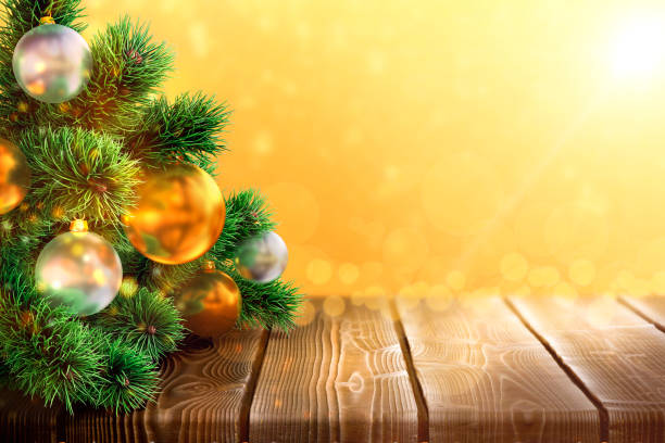 istock Chrismas tree branches on old wood table with gold and white toys. 1194092776
