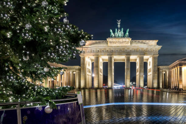 istock The Brandenburg Gate in Berlin, Germany, during winter night time with lit Christmas tree 1194093341