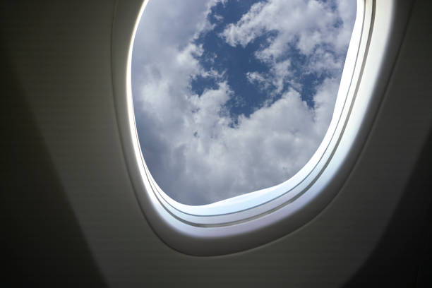 istock Airplane window overlooking the beautiful clouds and the earth. 1194095537