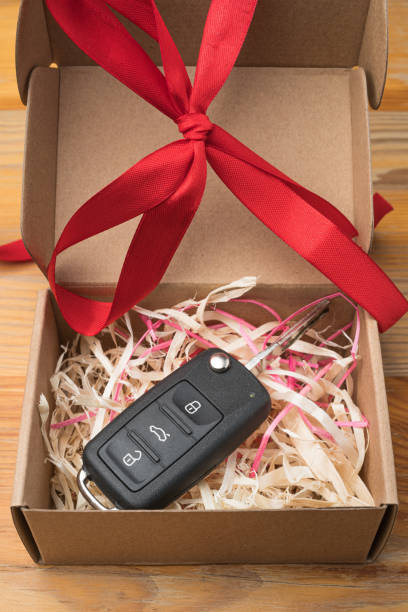 istock Car key in a paper box with red bow. 1194096518