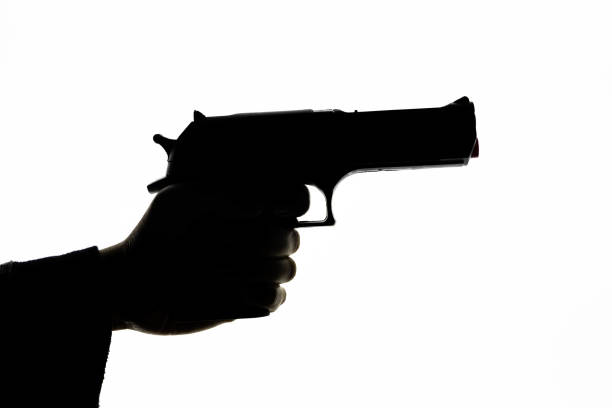 istock Silhouette Gesture Holding Handgun 1194097000