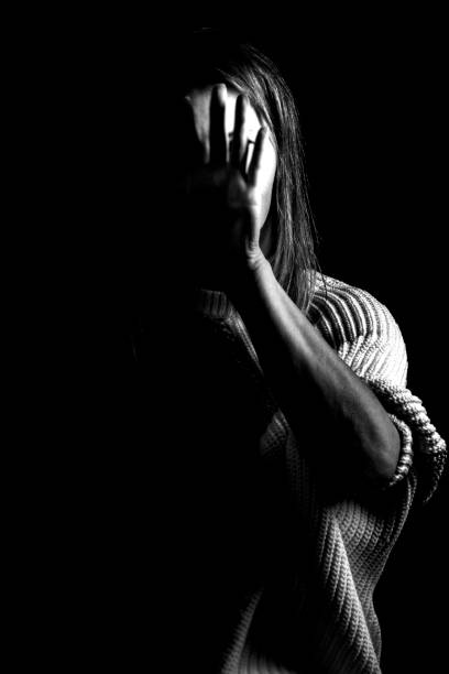 Black and white portrait of a woman showing sign stop. Woman showing gesture stop. Violence against women concept. Stop violence. obscured face photos stock pictures, royalty-free photos & images