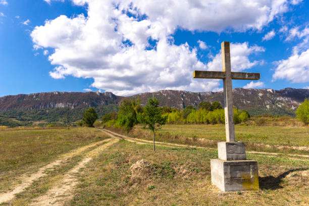 istock View at old stone cross on the mountain above clouds against blue sky 1194101076