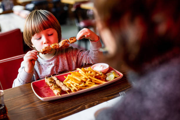 istock Young kid at brunch with his mother 1194102109