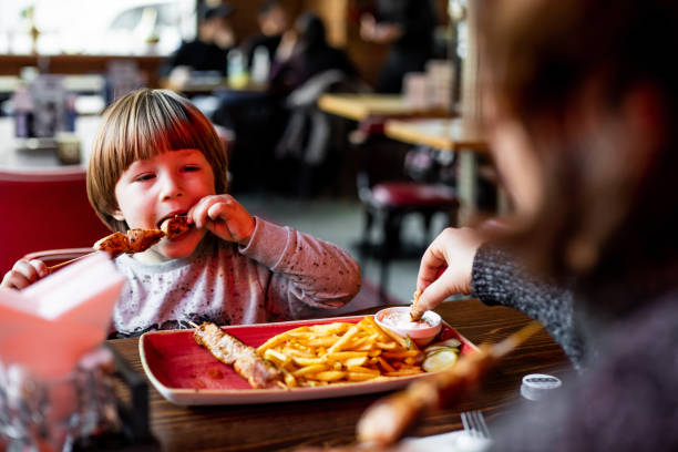 Young kid having a brunch in a restaurant
