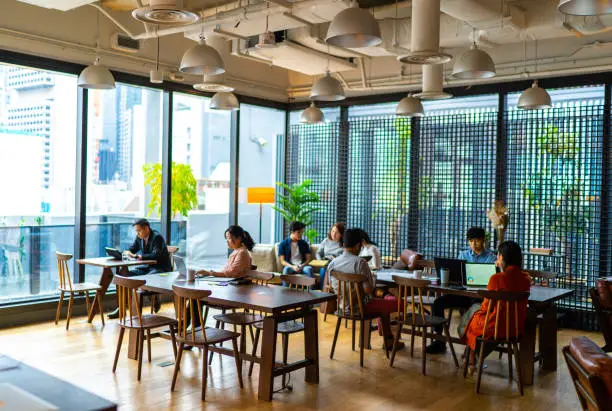 Photo of Asians Millennials busy working in co-working space.