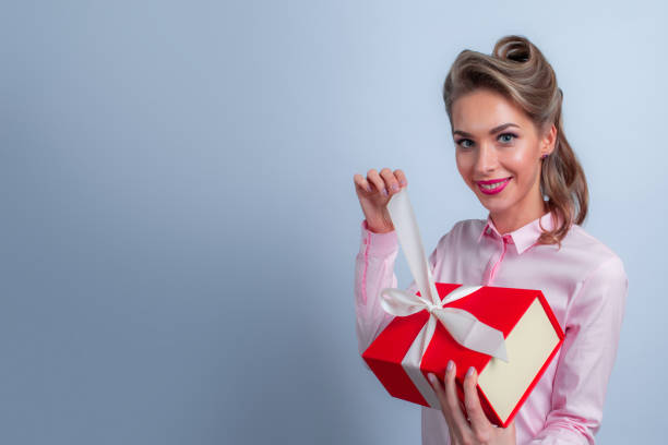 istock Happy woman with gift 1194105647