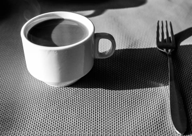 Coffee, newspaper and napkins with pictures, showing business breakfast