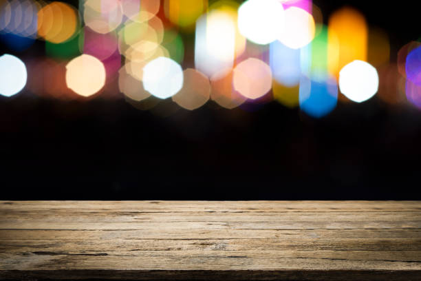 istock Empty wooden table platform and bokeh at night 1194109001