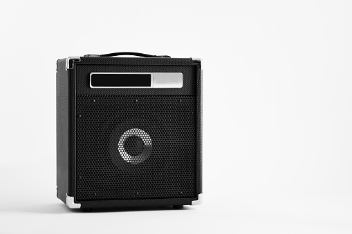 Black electric guitar bass amplifier or amp on white background.