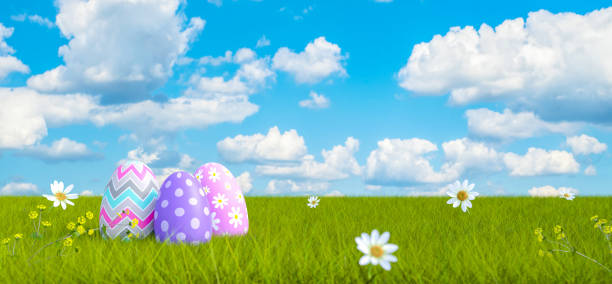 istock Colorful Decorated Easter Eggs on Green Meadow with Beautiful Blue Sky Clouds Background 3d render 1194109264