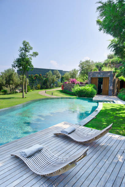 istock Deck chairs on Wooden plank floor against swimming pool 1194109319