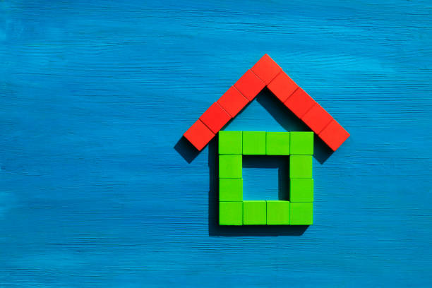 Wooden block house on blue background