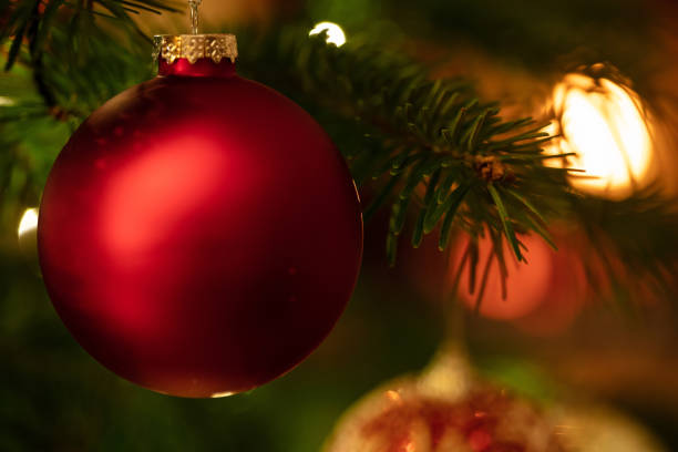 istock Christmas bauble hanging on a spruce, closeup view 1194110618