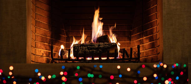 istock Christmas burning fireplace and lights, holiday decoration background 1194110631