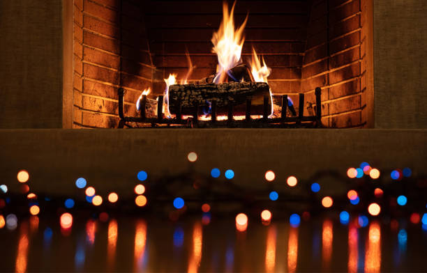 istock Christmas burning fireplace and lights, holiday decoration background 1194110636