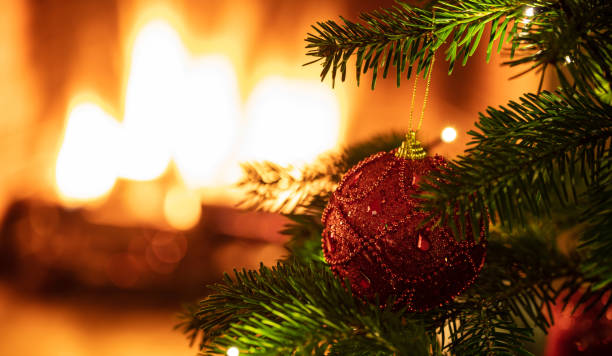 istock Christmas tree close up on blur fireplace background 1194110642