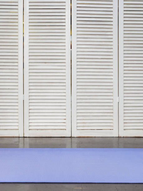 estera de yoga púrpura sobre fondo de pared de madera - school gymnasium parquet floor sport empty fotografías e imágenes de stock