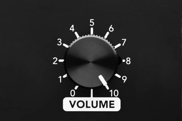 Volume control knob of a black amplifier on maximum loudness. Close up view with copy space.