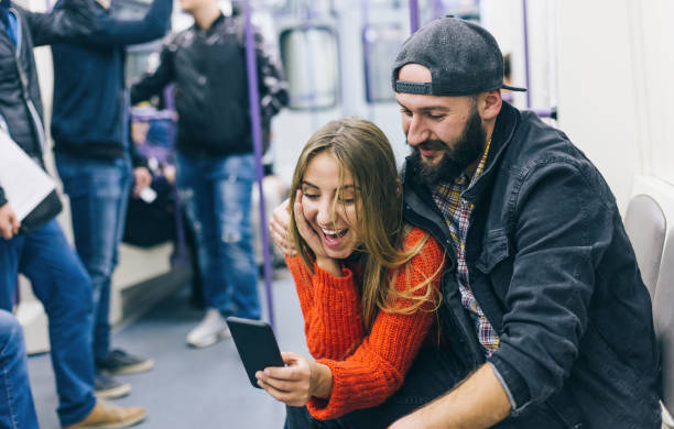 istock Couple texting in the subway train 1194115106