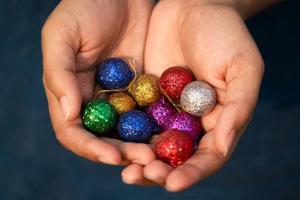 istock Person Holding Decorative Balls 1194116923