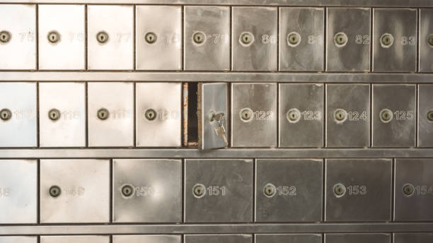 istock Half opened silver steel post office box (P.O. BOX) with keys inside the lock 1194118007