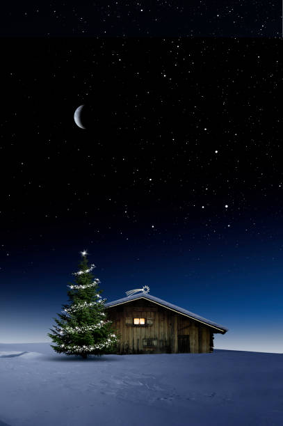 istock Christmas illuminated hut in cold winter night 1194118122