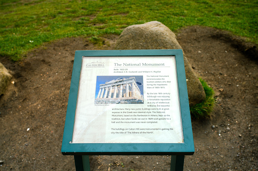 Edinburgh, Scotland - March 20, 2019 - Information of The National Monument of Scotland, a memorial to the Scottish soldiers and sailors who died fighting in the Napoleonic Wars, Calton Hill