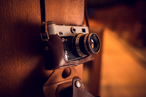 Retro camera on a wooden table, close-up