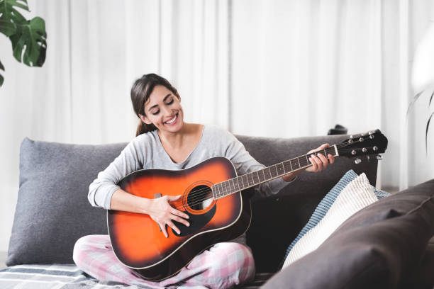 istock Young girl at home with a guitar 1194120376
