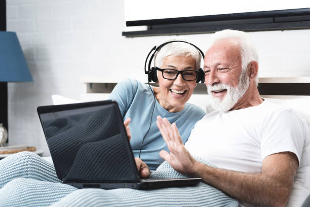 istock Elderly retired couple talking over the camera, skype call 1194120428