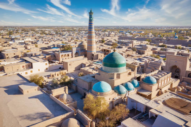 Khiva Хива Uzbekistan Old Town with Islam Khoja Minaret Xiva Aerial Drone point of view over the famous old city of Khiva - Xiva - Хива along the Silk Road with iconic islamic Islam Khoja Minaret -  tallest Minaret in Uzbekistan. Itchan Kala, Khiva - Chiva, Xorazm Region, Uzbekistan, Central Asia khiva stock pictures, royalty-free photos & images