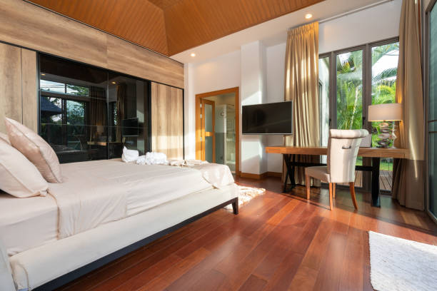 istock Modern bedroom with working desk and bedding 1194125055