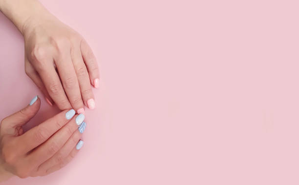istock female hands beautiful manicure on a colored background 1194129584