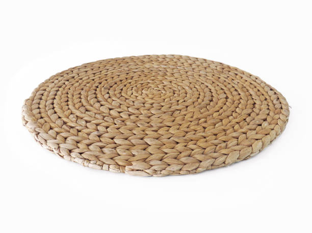 istock top view texture of handmade round beige wicker tablecloth surface isolated on white background; Close-up of single oval water mat of water hyacinth fabric. Rustic appearance Heat-resistant. Environmentally friendly. 1194130144