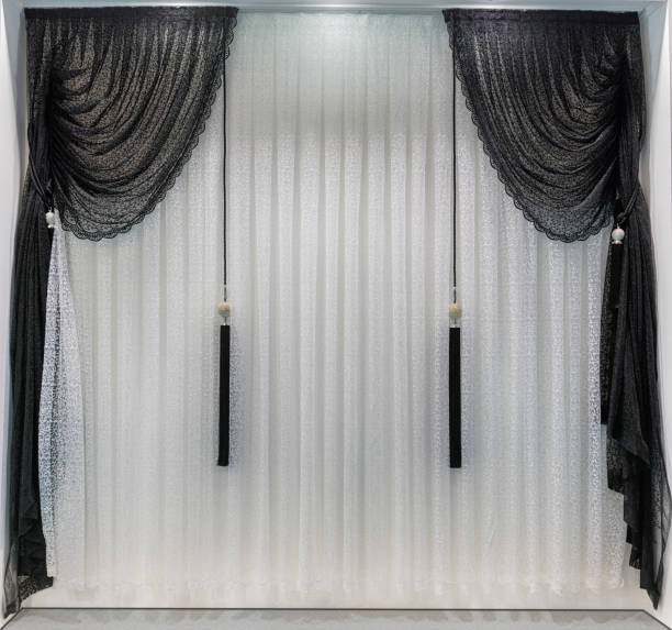 Contrast curtains in the design of a modern interior in black and white colors.