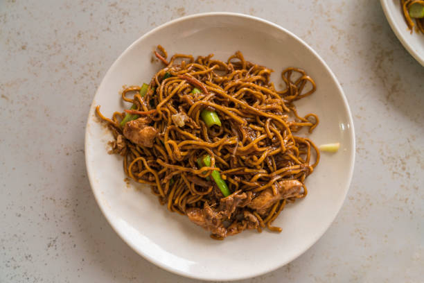 Chinese Style Chicken Chow Mein Meal Noodles Portion of Malaysian Chinese Style Chicken Chow Mein Meal With Egg Noodles traditional malaysian food stock pictures, royalty-free photos & images