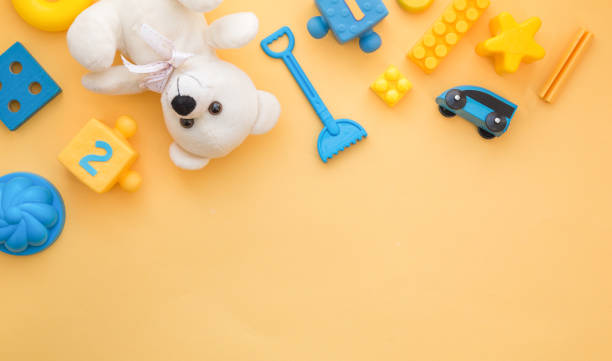 istock Kids toys frame on yellow backround. Top view. Flatlay. Copy space for text 1194138916