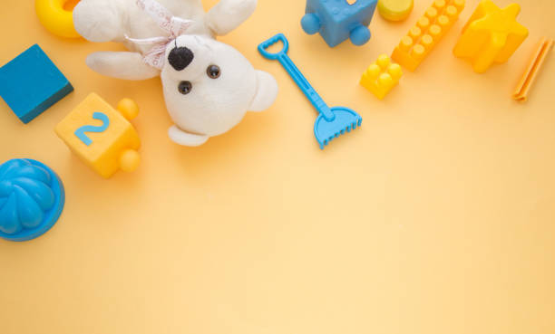 istock Kids toys frame on yellow backround. Top view. Flatlay. Copy space for text 1194138917