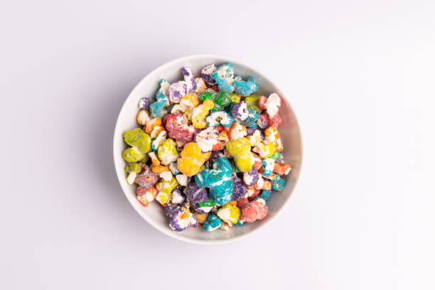istock Colored Popcorn candy isolated on white background, soft light, studio shot, copy space. Junk food, fruit flavored popcorn. Colorful, multicolor, candy coated popcorn 1194142557