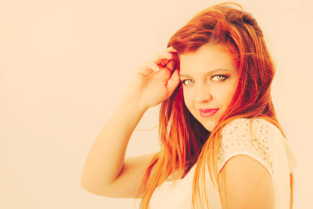 Portrait Of Redhead Woman Relaxing On Bench