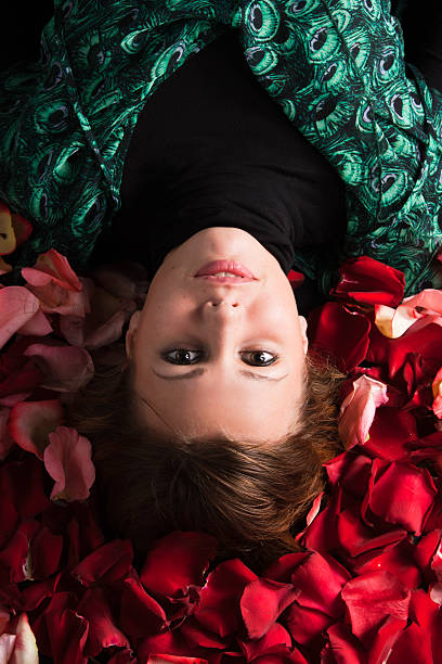 Woman on rose petals stock photo