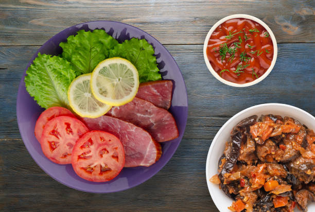 istock ham with salad, tomato and lemon on a plate. 1194143696