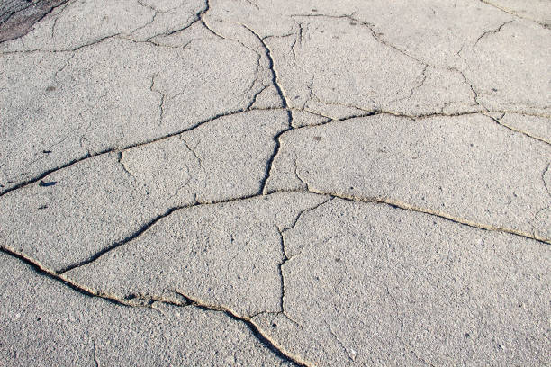 istock A Cracked asphalt. A background of asphalt. Cracks. 1194143993