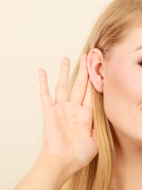 istock Woman putting hand ear to hear better 1194144938
