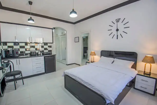 Photo of Interior design of bedroom in studio apartment with kitchen