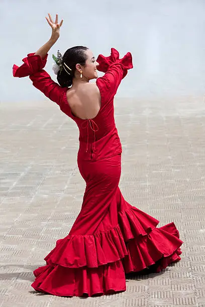 Woman traditional Spanish Flamenco dancer dancing in a red dress