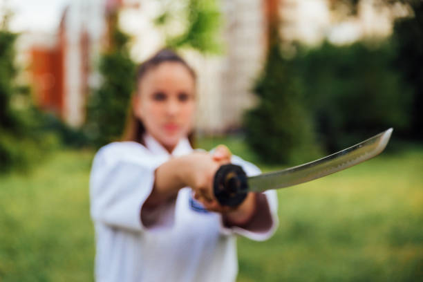 istock Karate girl with katana sword 1194152121