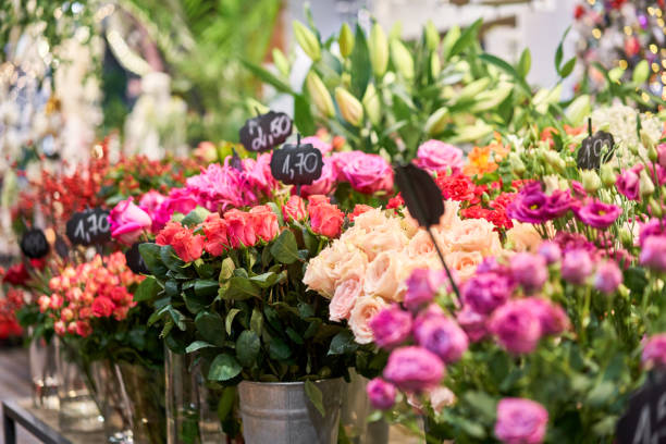 istock Vases with different colored flowers, showcase flower shop. Beautiful spring bouquets. . Small family business. Work florist. copy space 1194153302